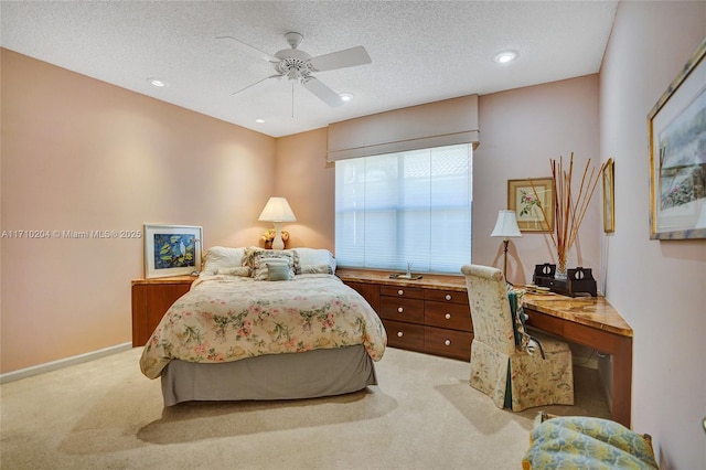 carpeted bedroom featuring a textured ceiling and ceiling fan