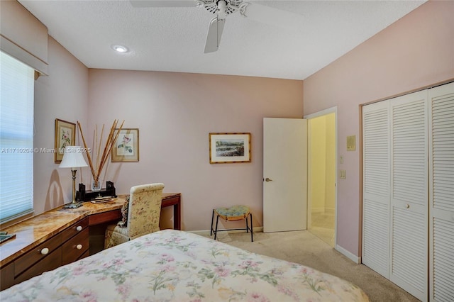 bedroom featuring a closet, ceiling fan, and light colored carpet