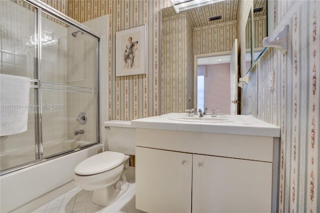 full bathroom featuring tile patterned flooring, vanity, toilet, and enclosed tub / shower combo