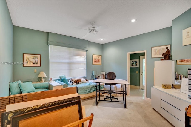 carpeted bedroom with ceiling fan and a textured ceiling