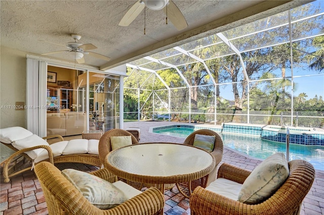 view of pool with a lanai, ceiling fan, and a patio area