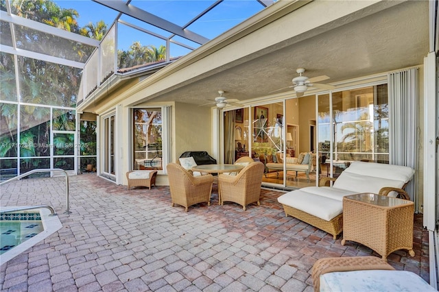 view of patio / terrace with ceiling fan, an outdoor hangout area, and glass enclosure