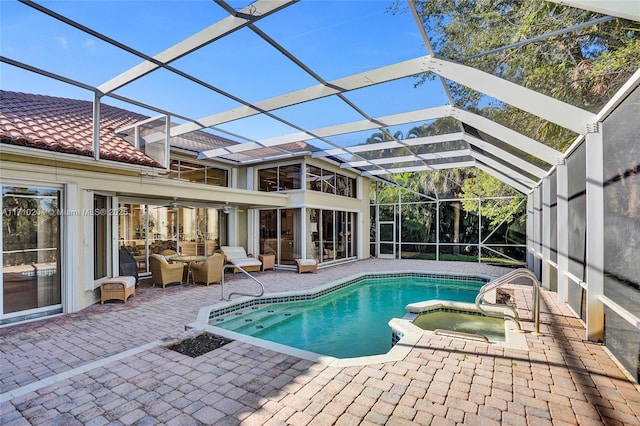 view of swimming pool with an in ground hot tub, a patio, glass enclosure, and ceiling fan