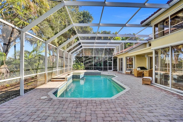 view of swimming pool featuring a patio and glass enclosure