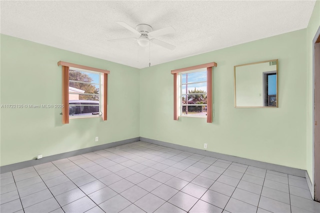 unfurnished room featuring light tile patterned floors, a textured ceiling, and ceiling fan