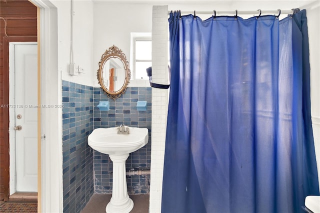 bathroom with tile walls