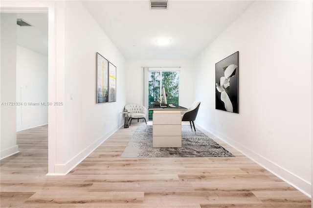 unfurnished office featuring light hardwood / wood-style floors