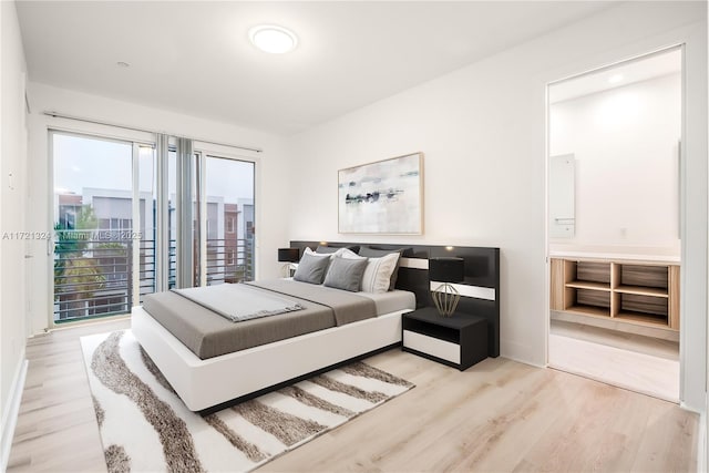 bedroom featuring access to outside and light wood-type flooring