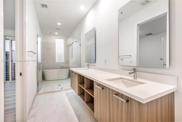 bathroom with vanity and independent shower and bath