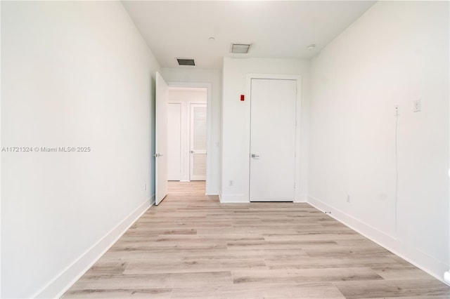 spare room featuring light hardwood / wood-style flooring