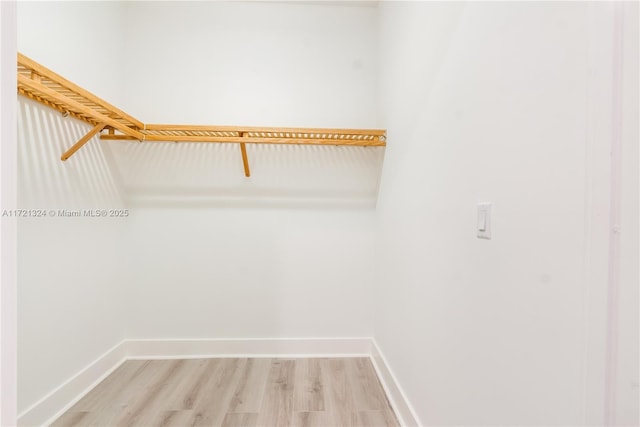 walk in closet featuring light hardwood / wood-style flooring