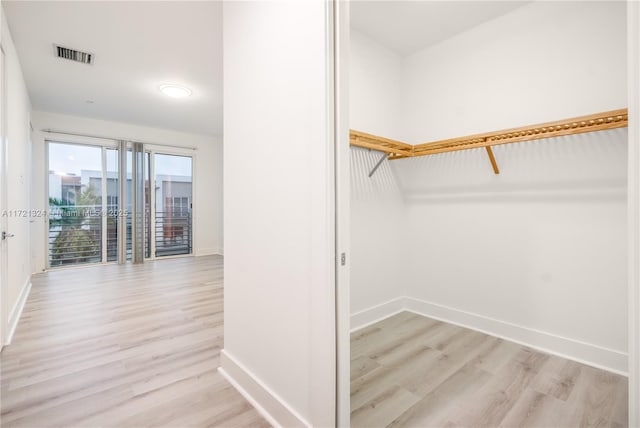 spacious closet with light hardwood / wood-style floors