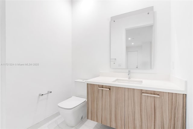 bathroom featuring toilet, vanity, and tile patterned flooring