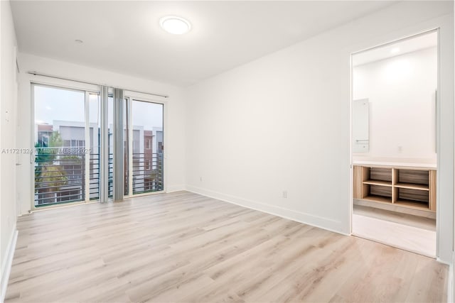 unfurnished room with light hardwood / wood-style floors