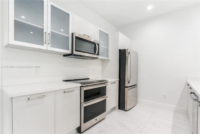 kitchen featuring white cabinetry and stainless steel appliances