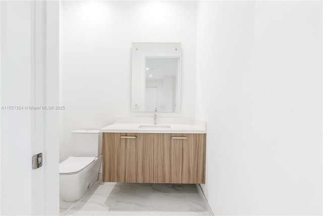 bathroom featuring toilet and vanity