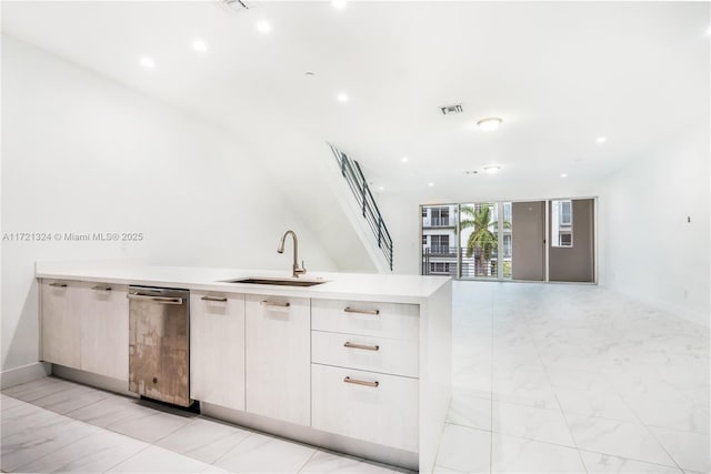 kitchen with white cabinets, a wall of windows, and sink