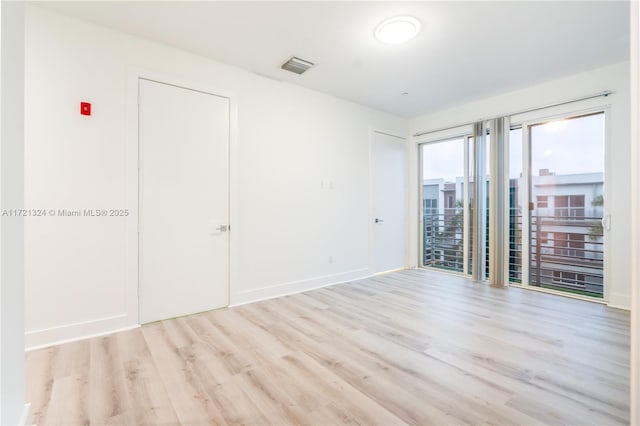 unfurnished room with light hardwood / wood-style floors