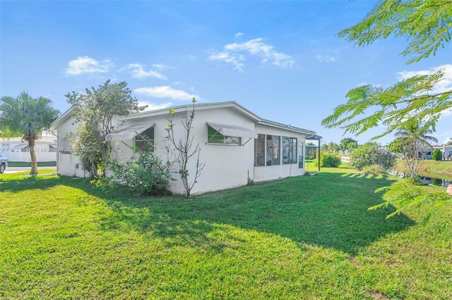 view of property exterior featuring a lawn