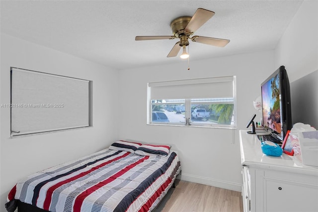 bedroom with light hardwood / wood-style floors and ceiling fan