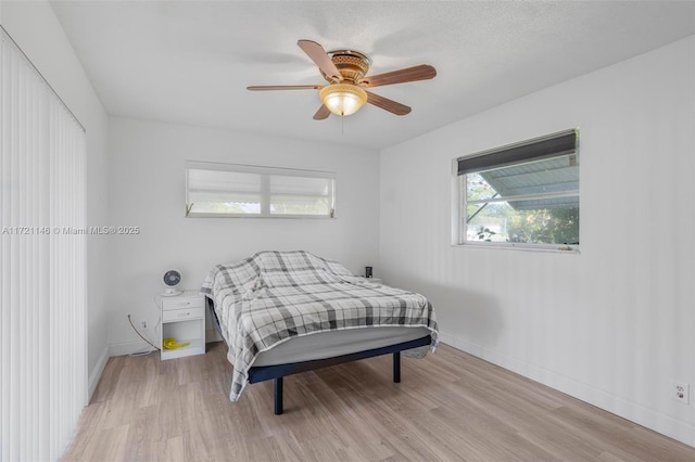 bedroom with ceiling fan and light wood-type flooring