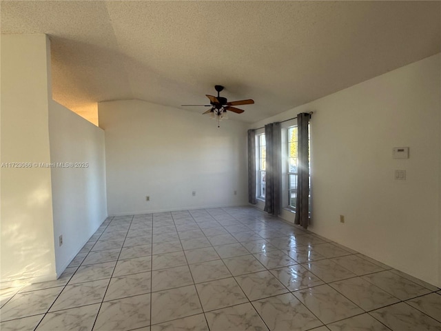 unfurnished room featuring ceiling fan, lofted ceiling, and a textured ceiling