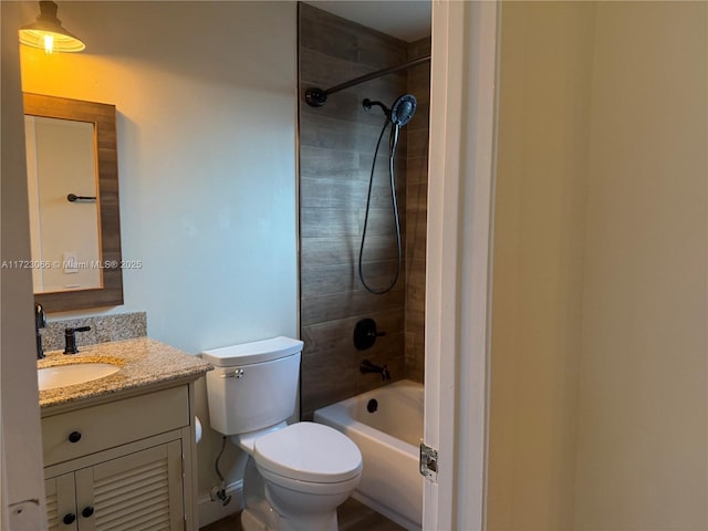 full bathroom with vanity, toilet, and tiled shower / bath