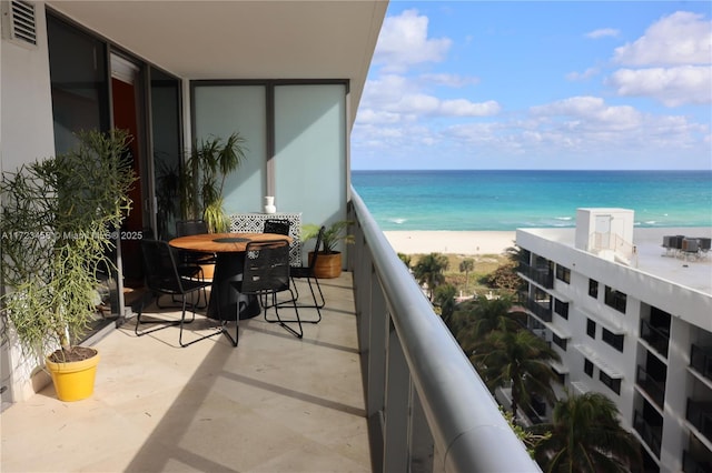 balcony featuring a water view and a view of the beach