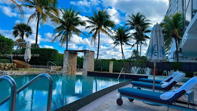 view of pool featuring pool water feature and a patio