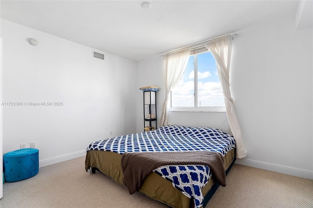 bedroom featuring light carpet