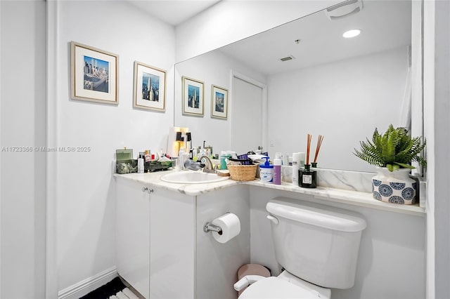 bathroom with vanity and toilet