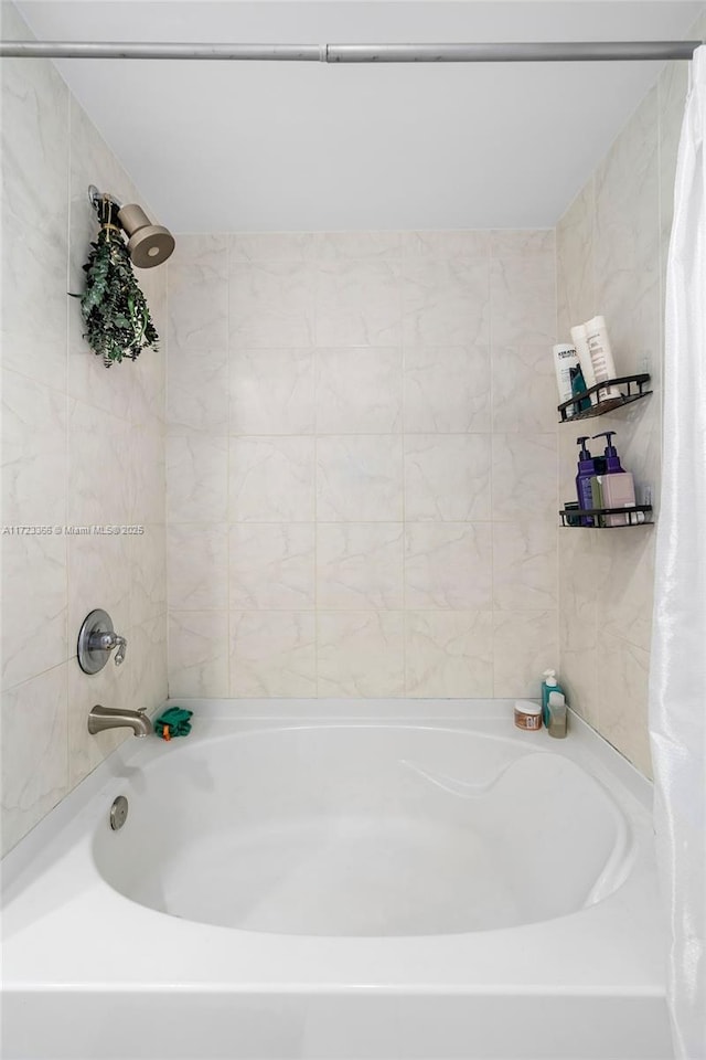 bathroom with shower / tub combo with curtain