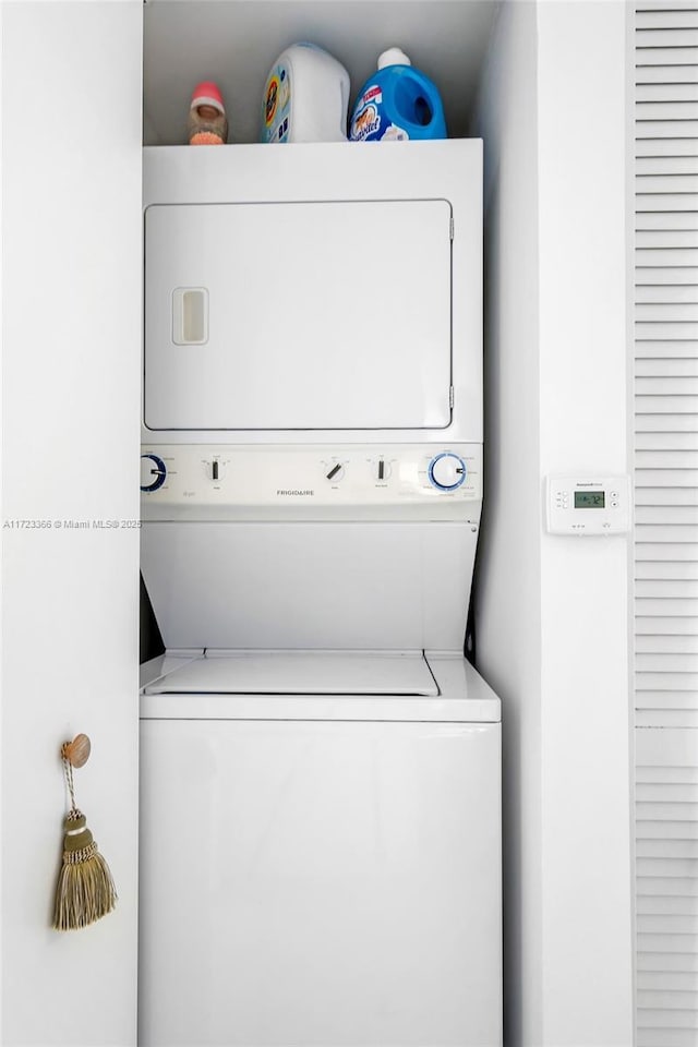 washroom with stacked washer and dryer