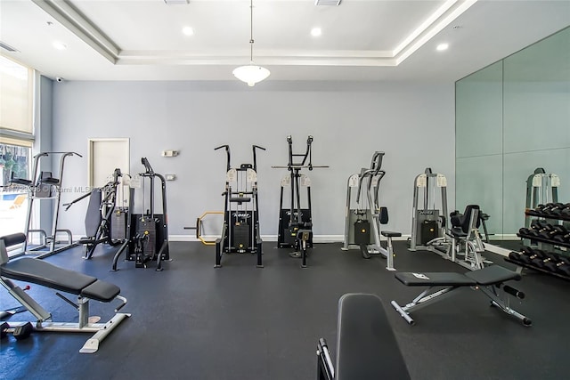 exercise room with a tray ceiling