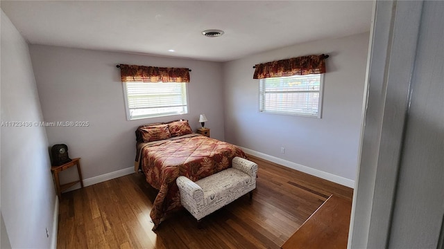 bedroom with hardwood / wood-style flooring