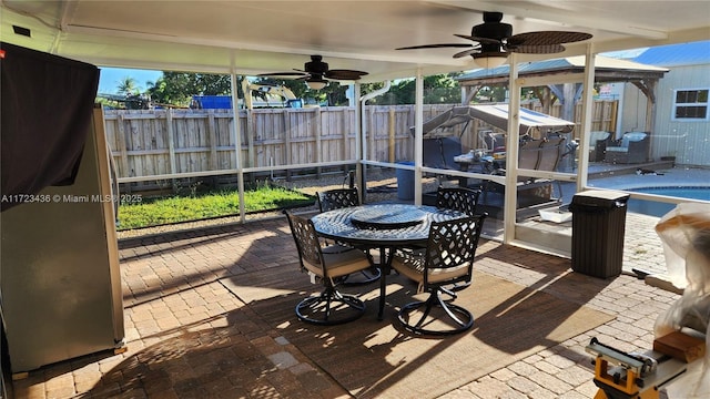 sunroom / solarium with ceiling fan and a healthy amount of sunlight