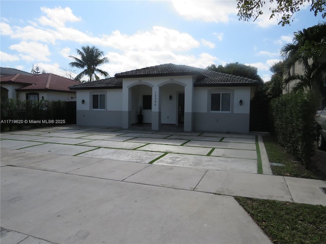 mediterranean / spanish-style house with a tile roof and stucco siding