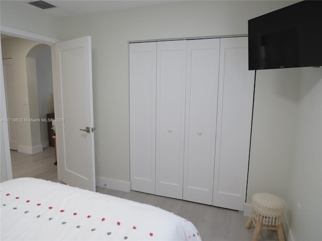 bedroom with a closet and light wood-type flooring