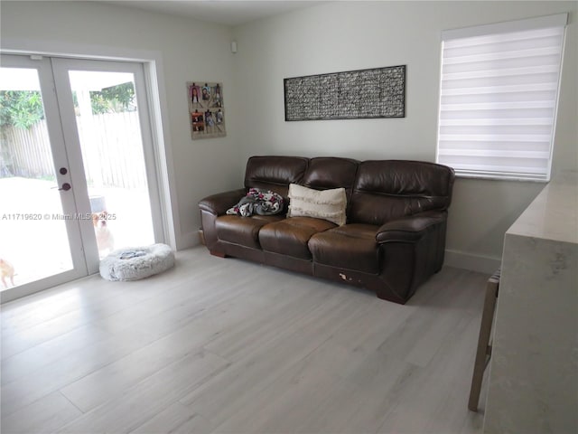 living room featuring french doors and light hardwood / wood-style flooring