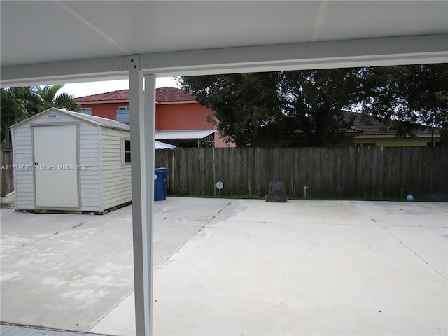 view of patio featuring a storage unit