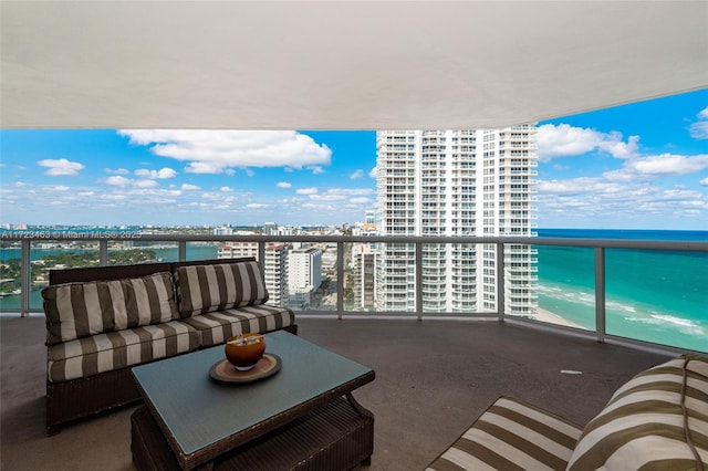 balcony with outdoor lounge area and a water view