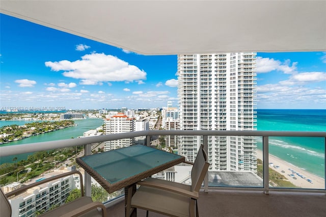 balcony with a beach view and a water view