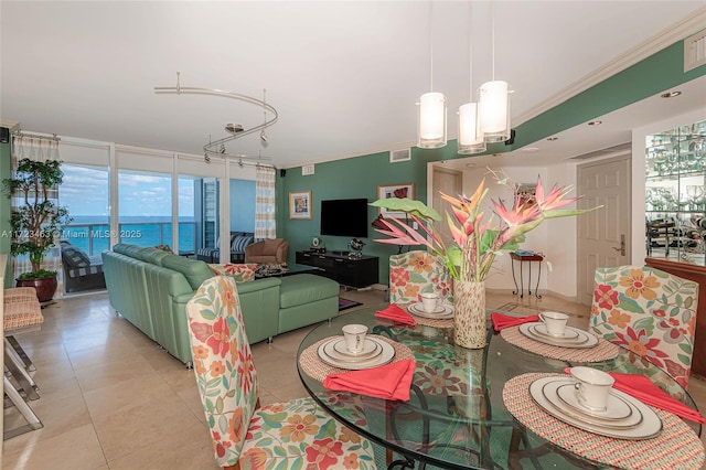 tiled dining space featuring expansive windows and crown molding