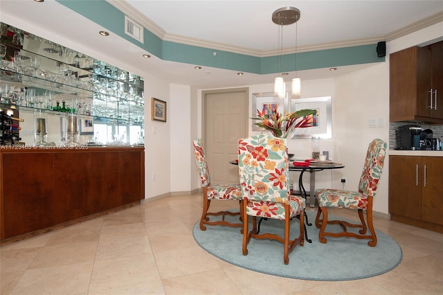 dining space featuring a raised ceiling, light tile patterned floors, and crown molding