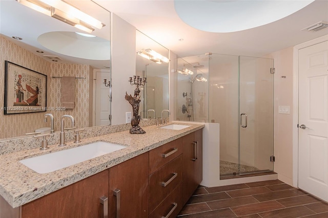 bathroom with walk in shower and vanity