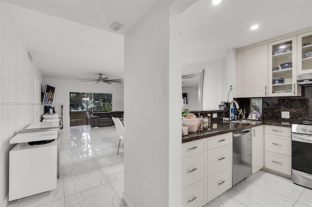 kitchen featuring ceiling fan, dark stone countertops, white cabinetry, and appliances with stainless steel finishes