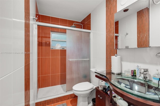 bathroom with tile patterned flooring, toilet, sink, and walk in shower