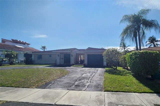 view of front of home featuring a garage and a front yard