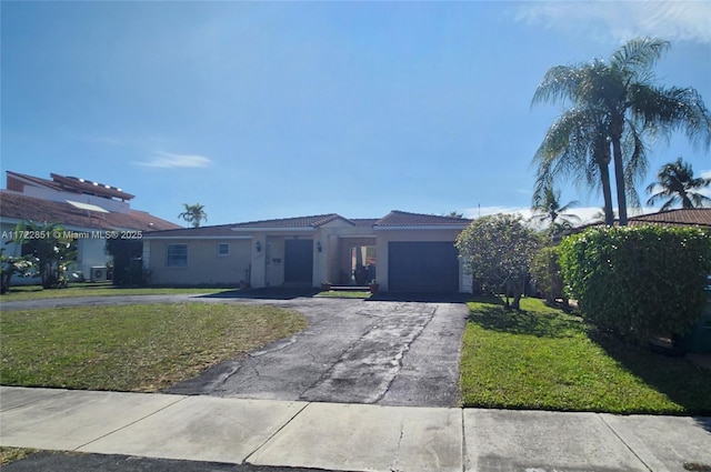 view of front of home with a garage and a front lawn