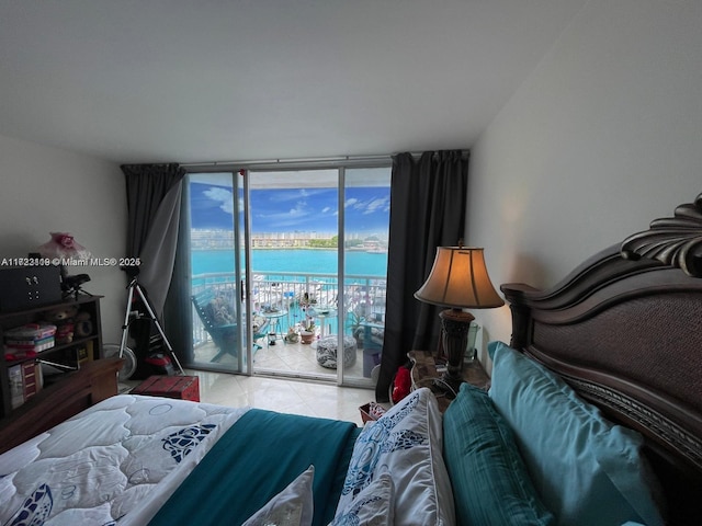 tiled bedroom featuring access to outside, expansive windows, and a water view